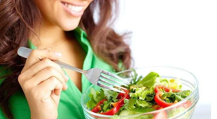 girl eats vegetable salad following a protein diet
